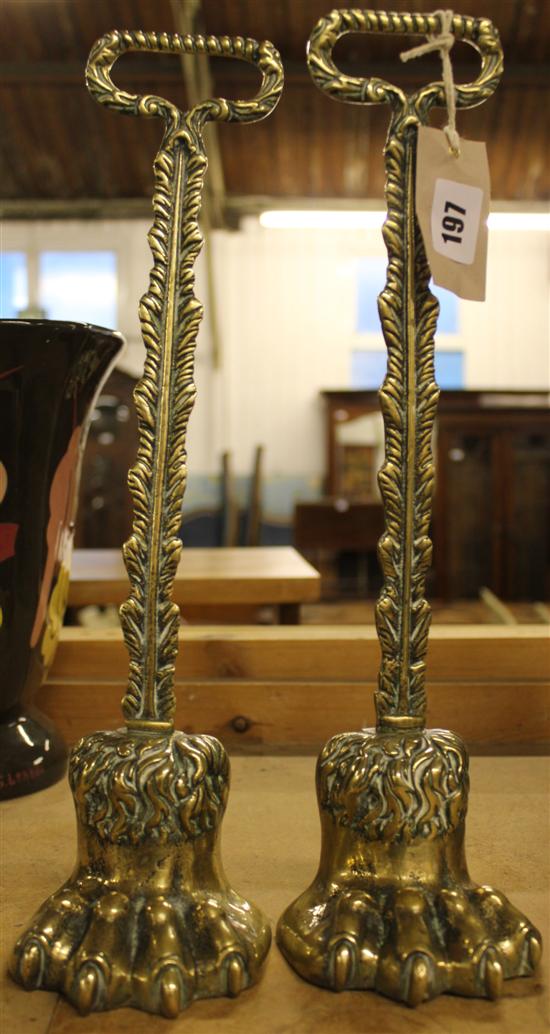 Pair early 19C cast brass hairy paw doorstops, with leaf stems & loop handles